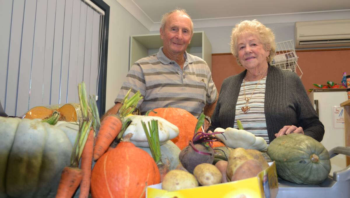 Roy Johnston hands fruit and vegetables from the Milton Show over the Rae Lalor at the Ulladulla Community Food Store.