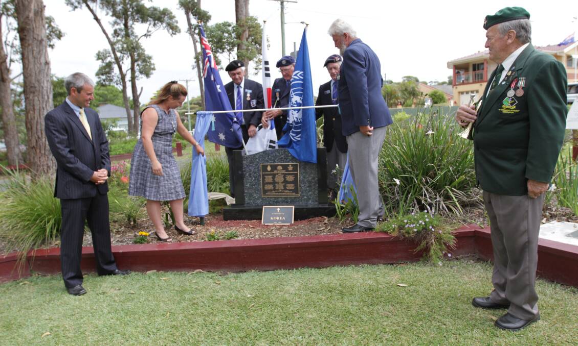 NOT FORGOTTEN: Simon and Kayleen Law watch Les Harris, John Tully and Keith Hanchard unveil the plaque with RSL sub-branch president Paul Warren and bugler Peter Williams. 