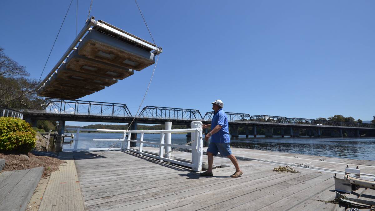 Marina designer and project manager Terry Chittleborough guides in another giant pontoon to build the Shoalhaven River Festival Marine Expo.