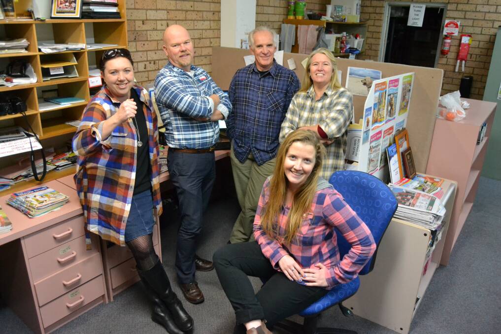 FREE STYLING: Getting ready for Flanno Friday at the end of the month are Times staff members Michelle Treweeke, Glenn Ellard, Ron Aggs, Debbie Ashcroft and Jess Clifford (front).