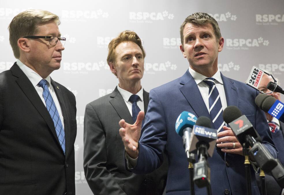 Deputy Premier Troy Grant (left) and RSPCA chief executive Steven Coleman listen while NSW Premier Mike Baird announces details of the Greyhound Racing Transition Plan at the RSPCA Centre at Yagoona on July 14. Picture: Jessica Hromas