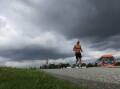 A man running under a cloudy sky at Flagstaff Hill on March 26, 2024 Picture by Sylvia Liber