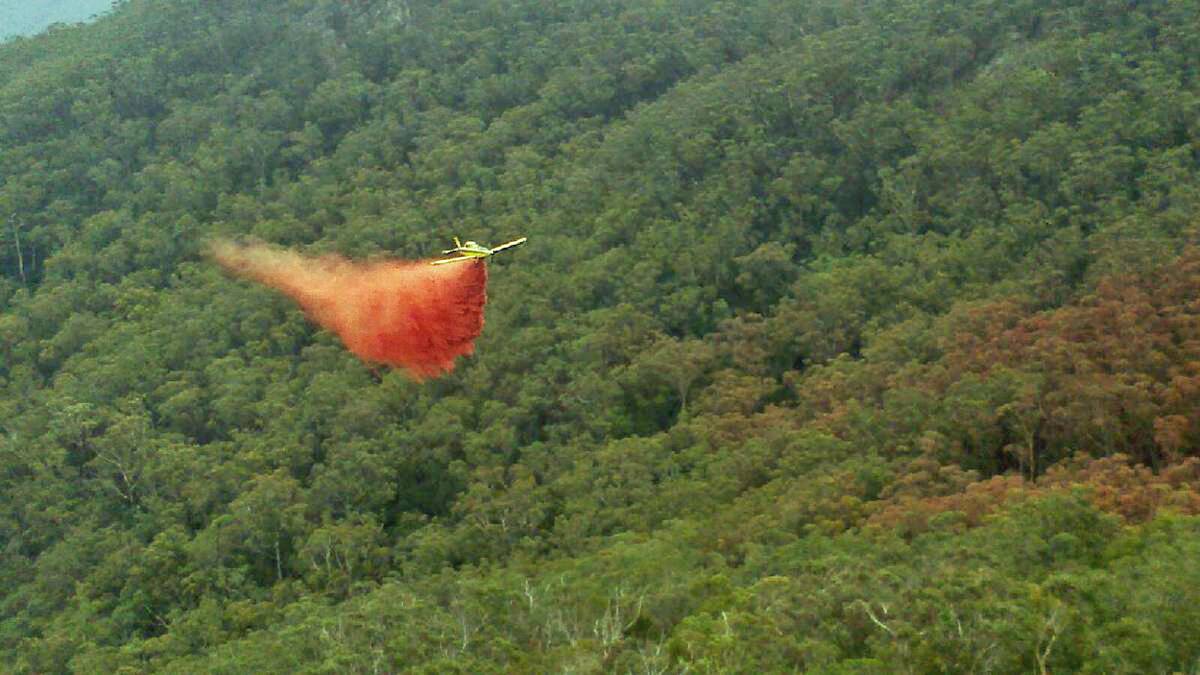 A fixed wing aircraft involved in firefighting operations has crashed 10 nautical miles west of Ulladulla. Pictured: A light aircraft in action fighting the Wirritin blaze.