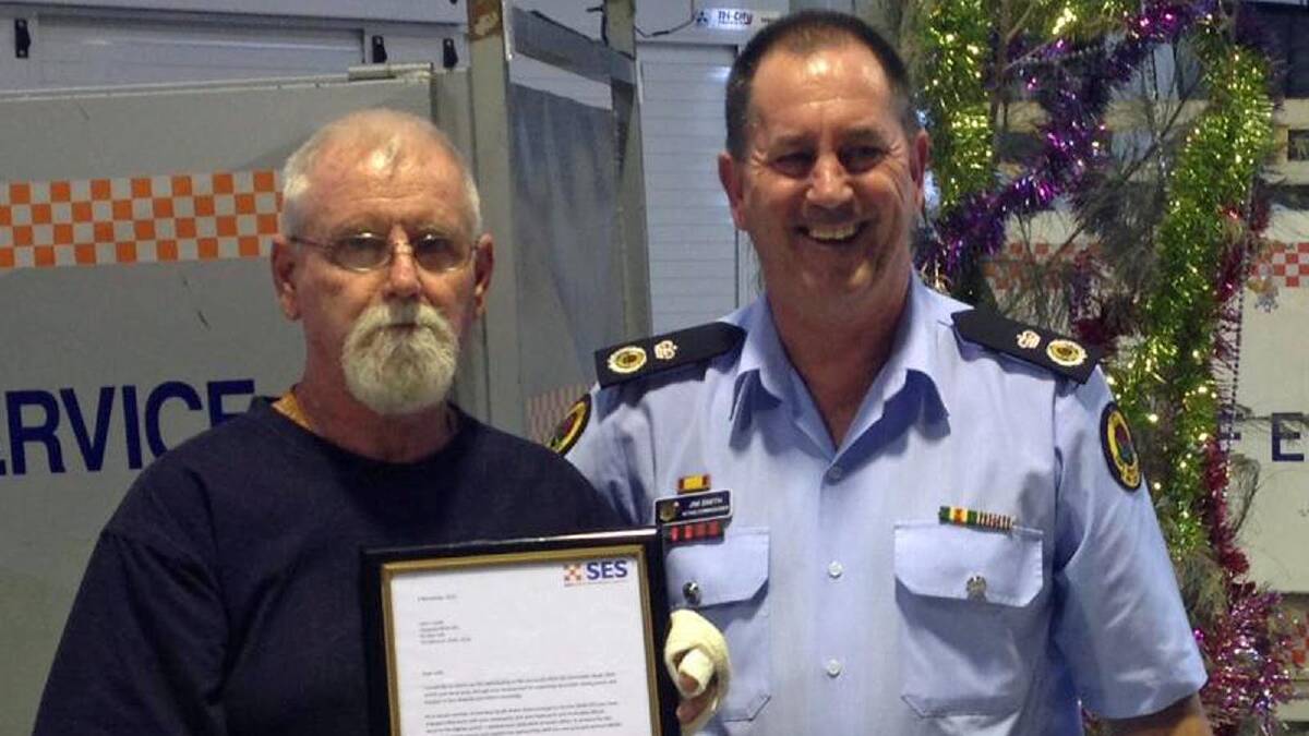 PRESENTED: Ulladulla SES community engagement officer John Clarke receives recognition from NSW SES Acting Commissioner Jim Smith.