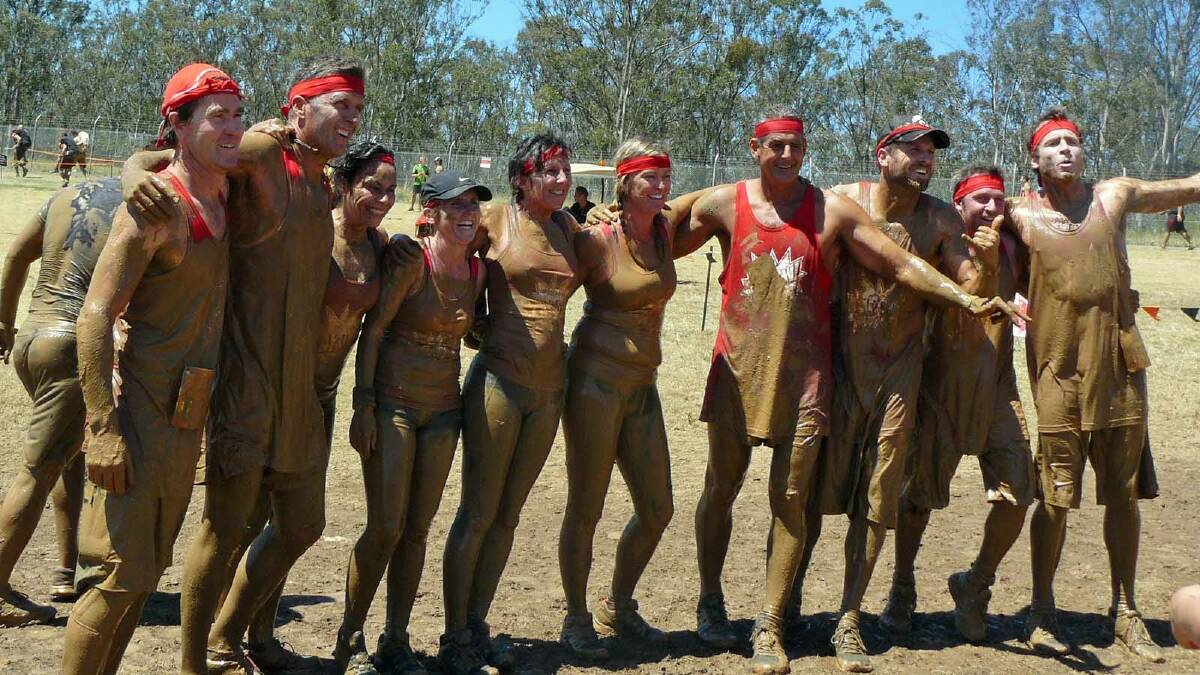 HAPPY AS PIGS IN MUD: Steph Wild, Mick Pitt, Moo Dath, Mel Doyle, Gail Wild, Deb Elkins, Jeff Mack, Brad Parsons, Jim Doyle and Graeme Parsons after they completed the Tough Mudder event.