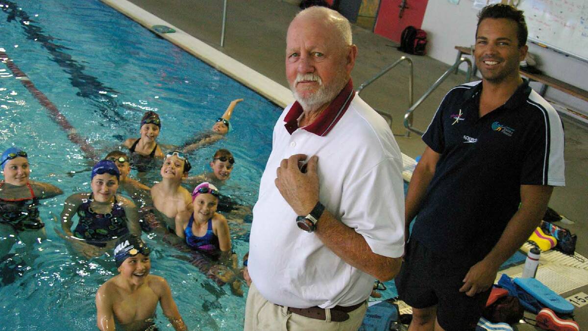 IN THE SWIM: Internationally renowned swim coach Doug Frost (front) shares some tips with squad coach Dene Roulstone and young swimmers at the Ulladulla Leisure Centre.