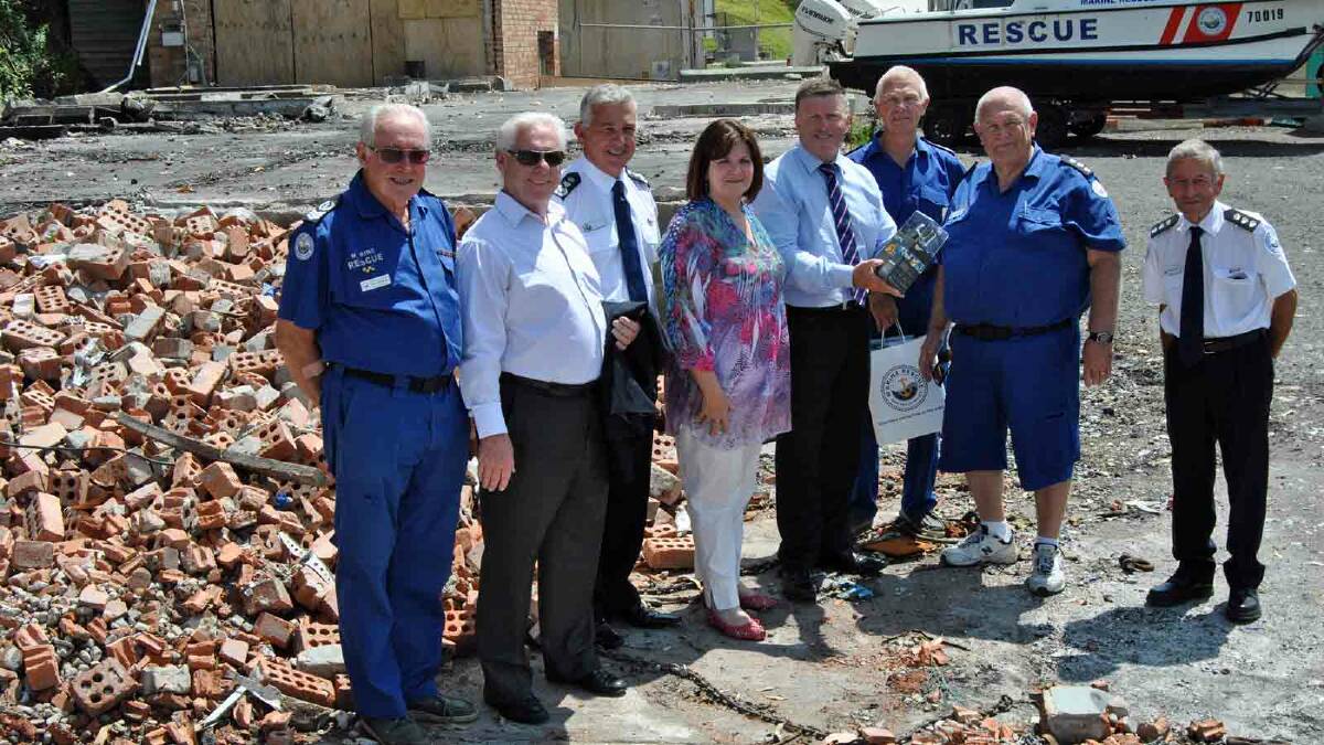 FROM THE ASHES: Ulladulla Marine Rescue volunteer Keven Marshall (left), general director Jim Glissan QC, Commissioner Stacey Tannos, Shelley Hancock MP, Minister for Police and Emergency Services Mike Gallacher, volunteer Doug Musker, commander Ken Lambert and Illawarra regional controller Bruce Mitchell inspected the recently cleared site of the Marine Rescue blaze and at the same time launched a new GoPro camera program last Wednesday.