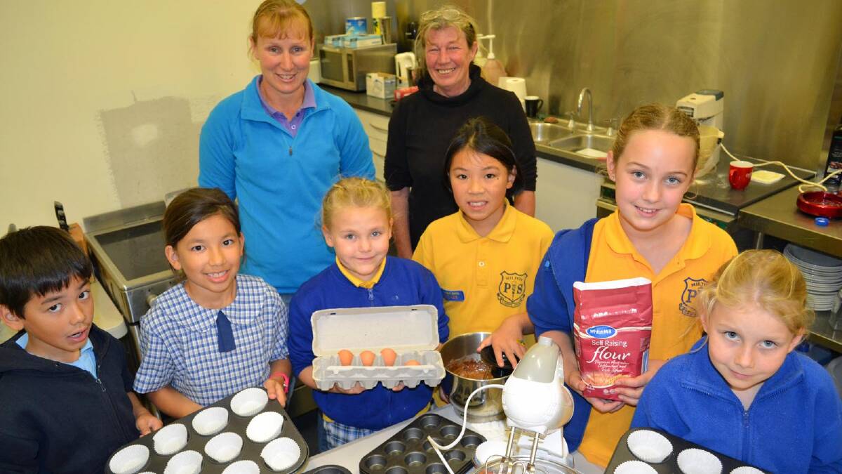 CROWDED COOKERY: Unicef Juniors leader Penny Stein pictured with Gayle Dunn and members Marcus and Stella Chan, Jacinta Halstead, Jaimee Soo, Emily Stein and Neve Lawson in the kitchen being expanded with Ulladulla ExServos Club funds. Photo: Kate Ryan
