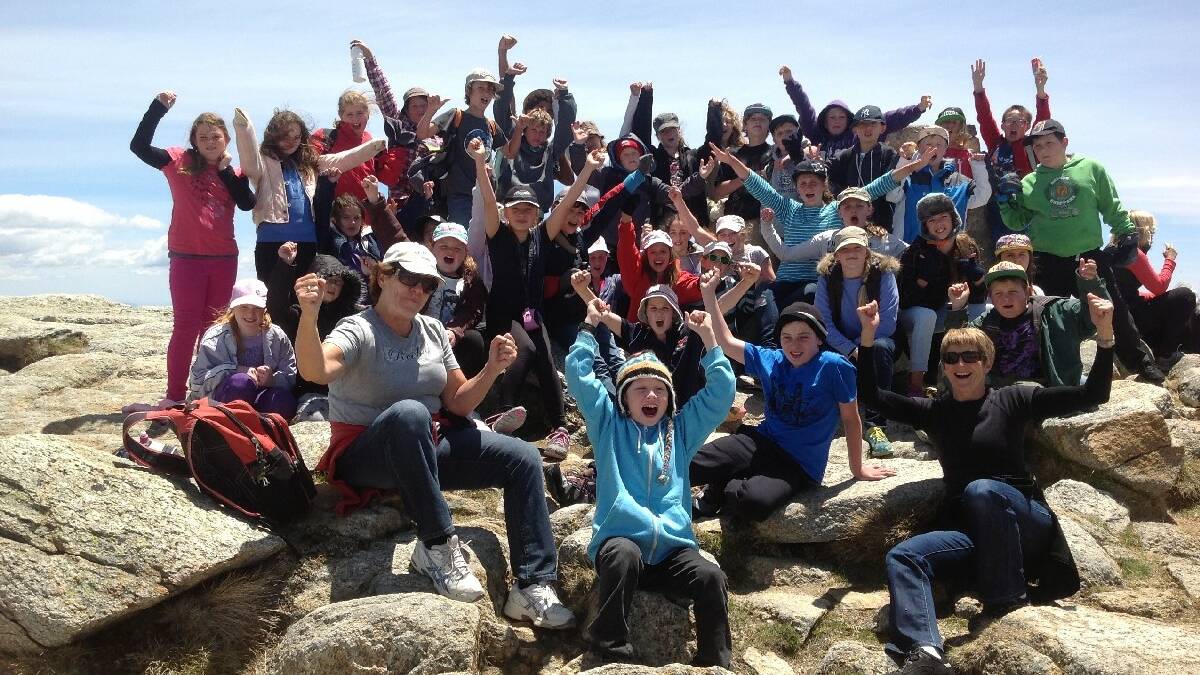 PAMBULA: Pambula Public School on top of the   world Mrs Murphy and Sue Beasley with the year   5 students on the top of Mt Kosciuszko.