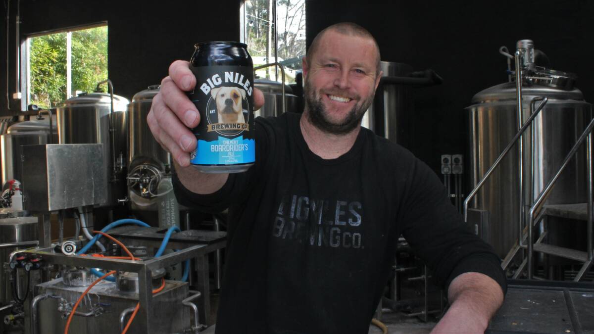 Big Niles Brewing Co founder and brewer Cam White with a Dalmeny Boardriders Ale at the Dalmeny brewery.