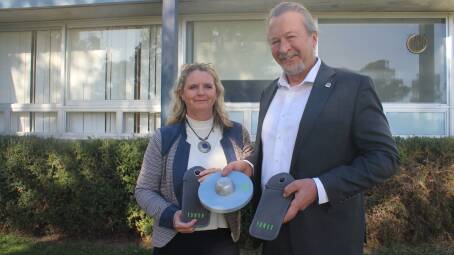 Bay High School principal Paula Hambly and Moruya High School principal Richard Schell with the phone pouches and magnetic opening device they have both implemented at their school. Picture: James Tugwell