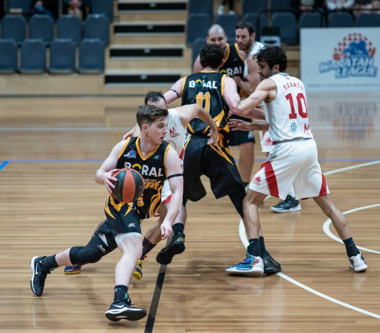 ON THE ATTACK: Tigers guard Joshua Watts uses the Kyle Leslie screen to attack the basket. Picture: Shoalhaven Basketball Association