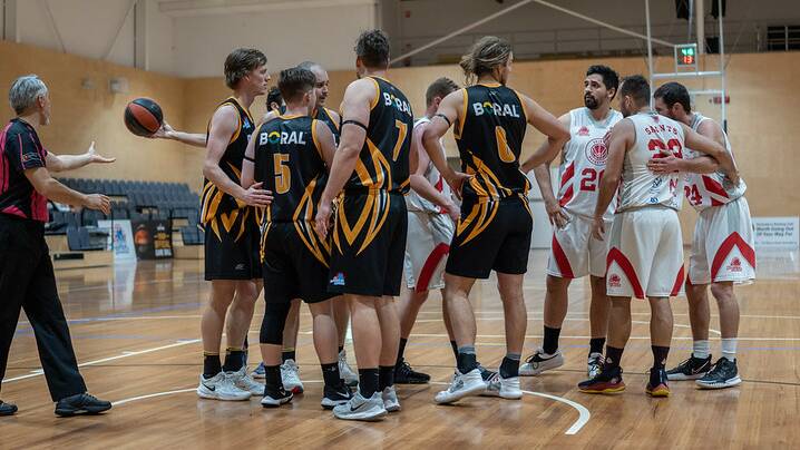 CLASH: The Shoalhaven Tigers and St George Saints huddle after a foul call. Picture: Shoalhaven Basketball Association
