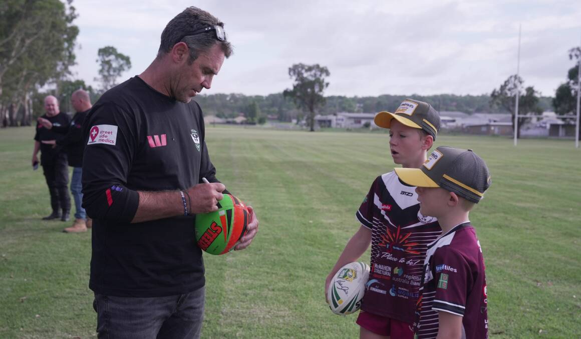 Brad Fittler signs autographs for young fans as part of the NRL Hogs Tour presented by Westpac. Picture supplied.