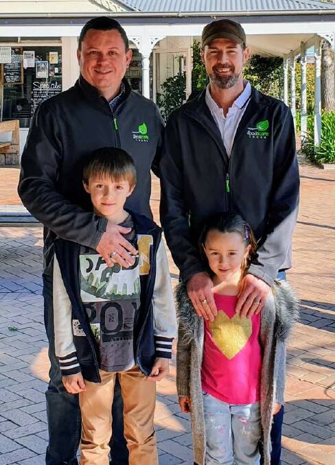 Berry business owners Cam Ayrton and Troy Weigall, pictured with children Brodie and Tully, are among the people putting out the rainbow-coloured welcome mat throughout March. Picture supplied.