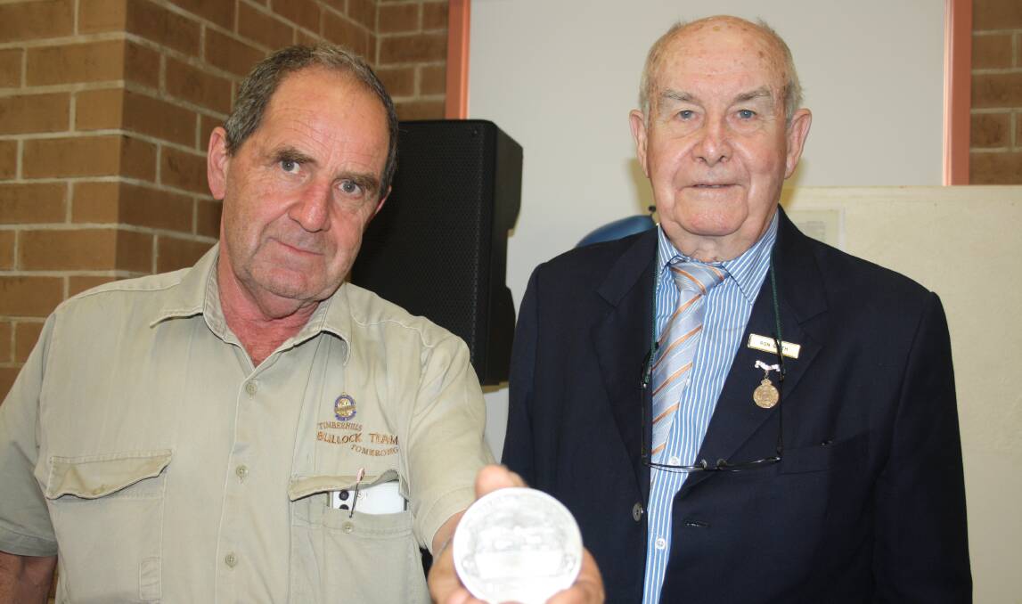 Tomerong's Ron McKinnon was presented with a special medal, recognising his years contributing to the Nowra Show, by Royal Agricultural Society councillor Ron Smith. picture by Glenn Ellard.
