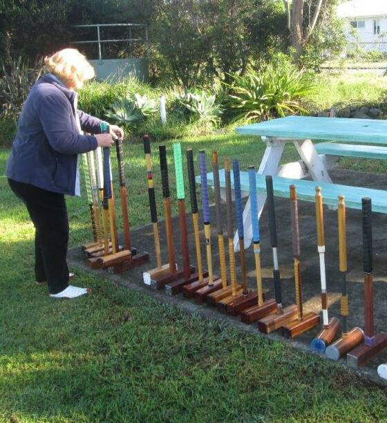 READY: Dee Carrington sets up the mallets ready for players at croquet.