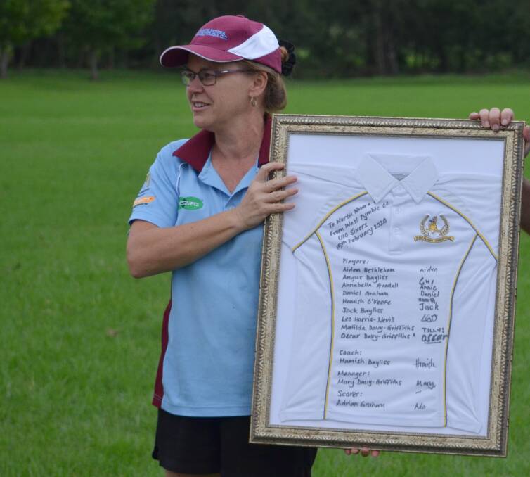 Lisa Kennedy accepts a West Pymble team shirt following friendly stage one friendly match the Sydney-based side and her North Nowra-Cambewarra Cricket Club last season. Photo: Supplied