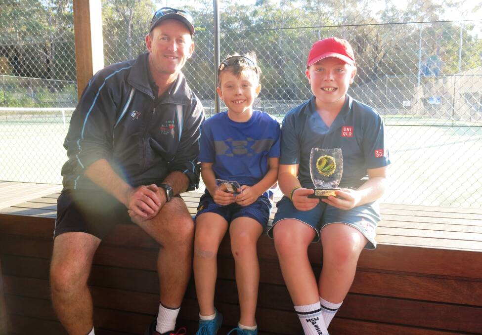 On the court: Coach Kevin Murphy with nine-year-old Baden Balding from Thirroul and 10-year-old Charlie Fannin from Bowral