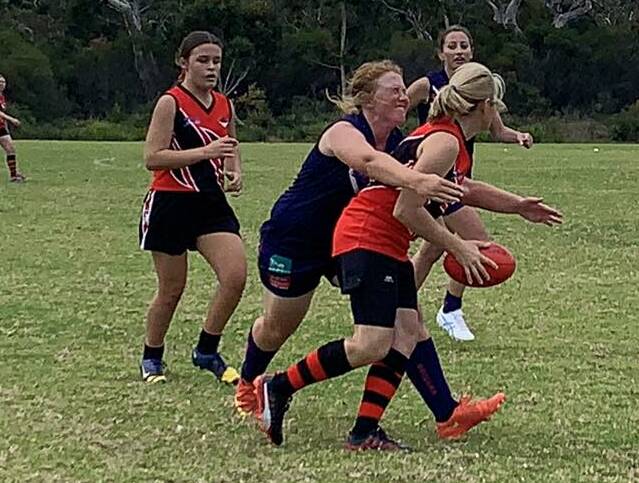 Dominant Dockettes: Ulladulla's Regan Taylor makes a tackle during the clash against Bay and Basin. Basin were no match for the Dockettes who won 53-0. Photo: Kimberley Peat