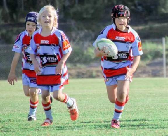 U8s players Kayla Lavington, with the ball, and Jay Hasler in their game against Sussex at the weekend.
