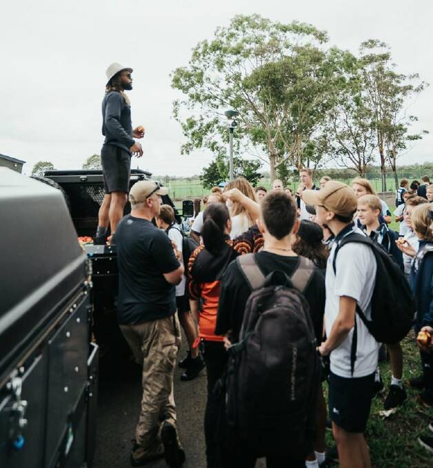 Patty Mills hands out fruit to Nowra High School students on Monday. Photo: TWITTER