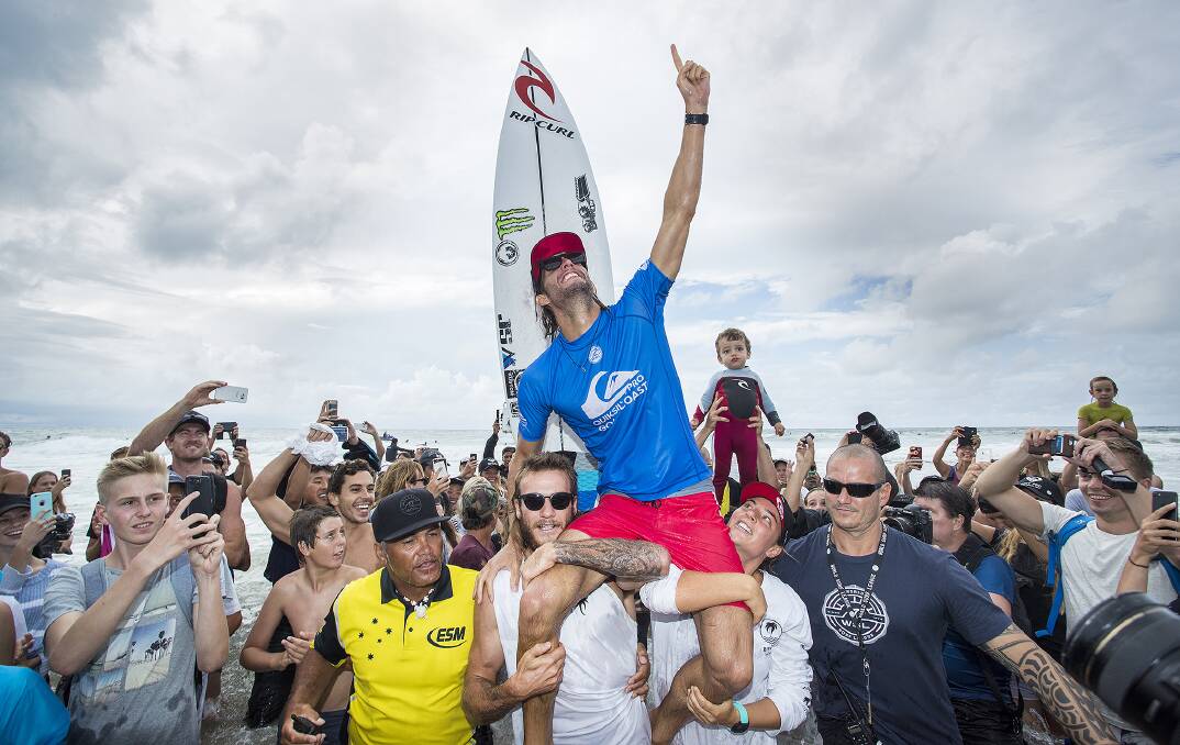 Mikey and Tyler Wright carry brother Owen up the beach after winning the 2017 Quiksilver Pro Gold Coast. Photo: WSL