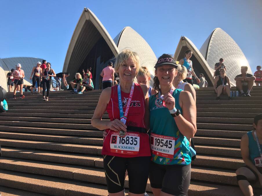 Top times: Maree Randall and Cheryl Garin with their well-earned medals at the end of the Blackmores half marathon in Sydney on Sunday.