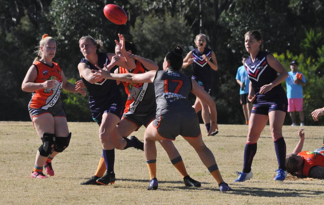 Show of strength: Shannon Lloyd bursting through traffic during the game against Dapto. The Dockettes finished the game with 14 players.