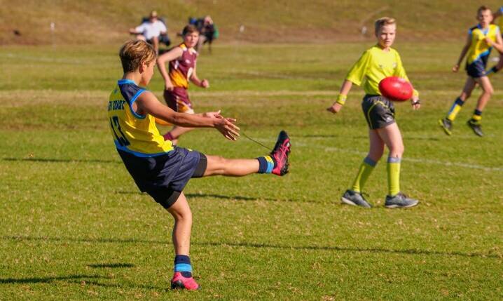 Mikey Salafia kicks to an AFL South Coast team made during the PSSA carnival.
