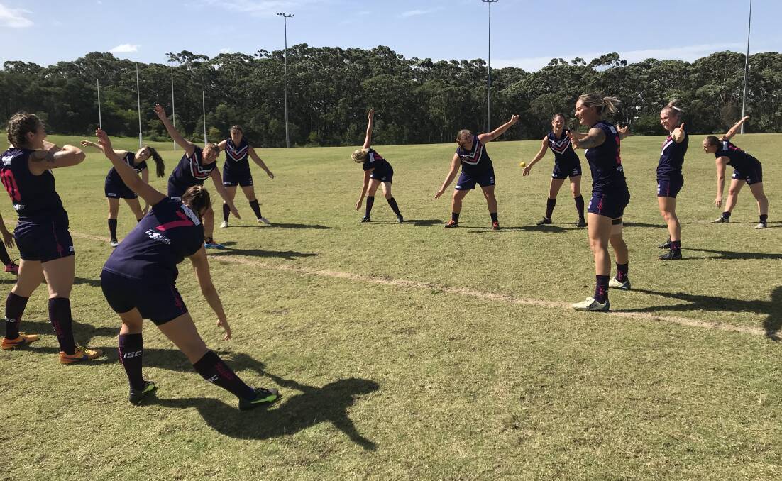 Warm-up: The Dockers women's AFL side, led by Cian Maciejewski, warming up before the clash with Northern District Tigers.