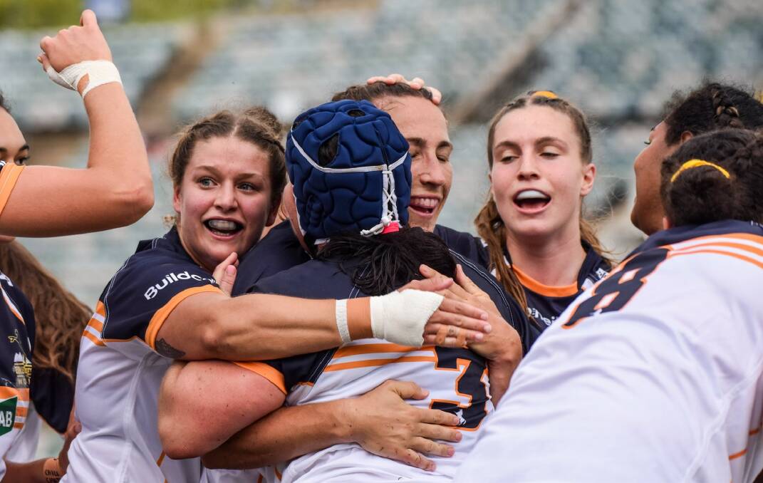 Harriet Elleman (left) and her ACT teammates celebrate a try on Saturday. Photo: BRUMBIES MEDIA