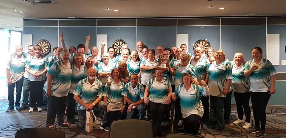 Celebrations: The Ulladulla darts team has grabbed back the Warilla v SSDA trophy with a strong win over Warilla. One 180 was scored on the day by Alan Shapley.