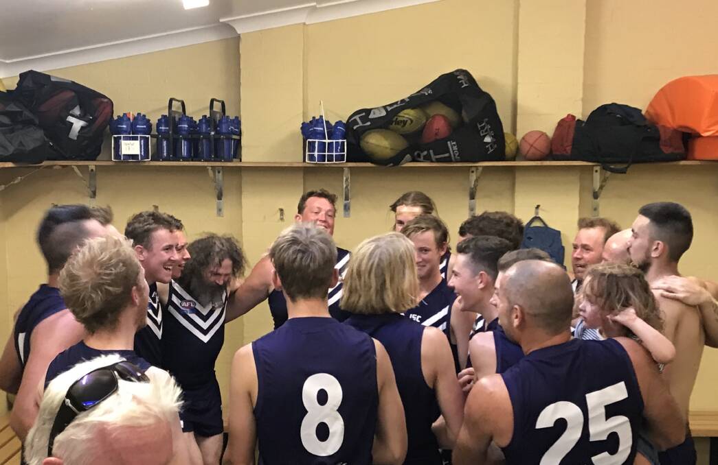 Celebration: The Dockers AFL side sings the victory song after taking down the Northern District Tigers at the weekend.