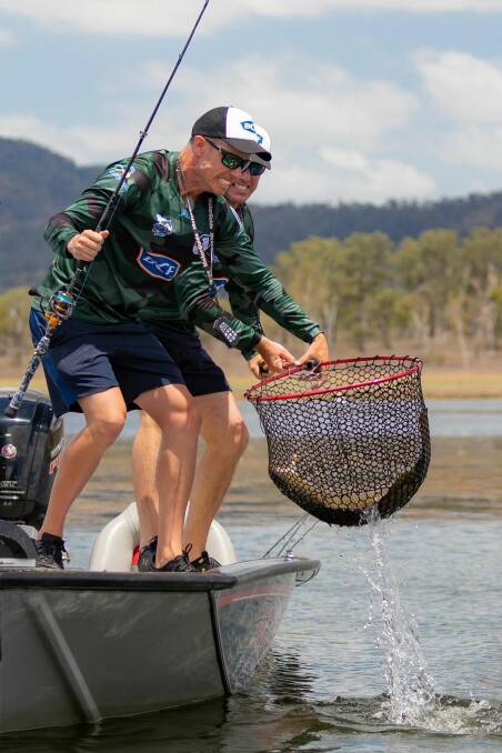 Liam Carruthers and Mark Healey catch a fish at Mackay. Photo: Adam Royter
