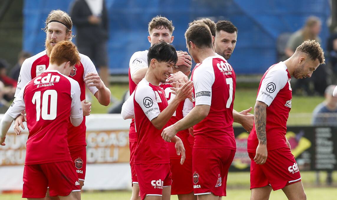 Chris Price and his Wollongong Wolves celebrate a goal. Photo: Anna Warr