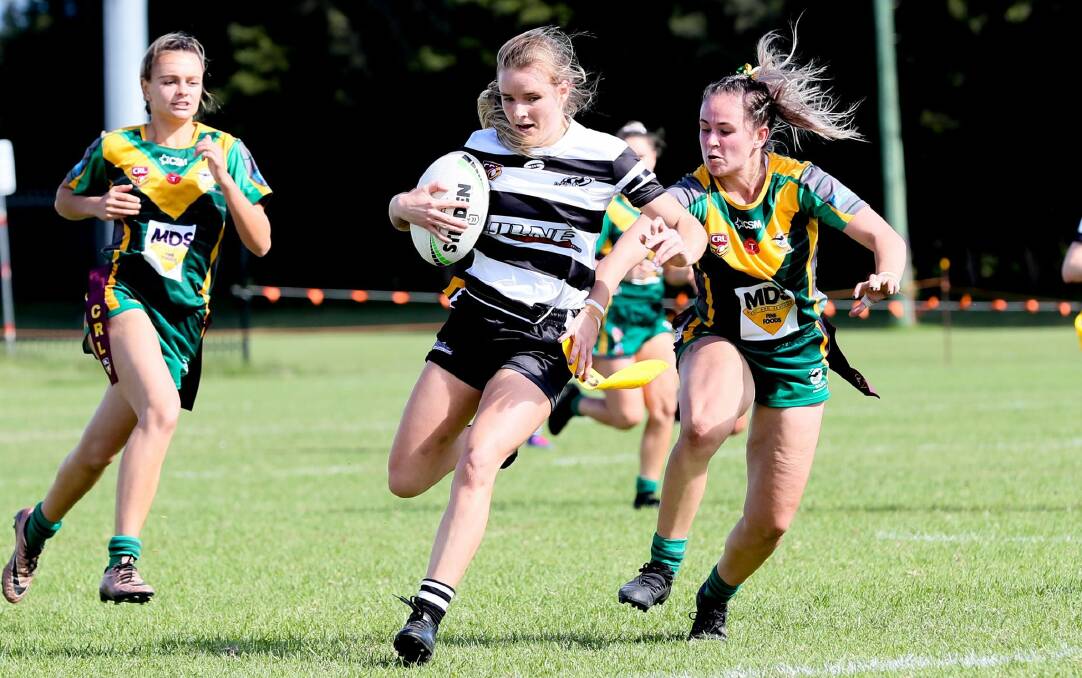 Berry-Shoalhaven Heads' Bree Rogers tries to avoid being tagged by a Stingrays of Shellharbour opponent. Photo: Giant Pictures