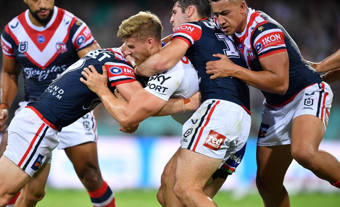 Jack Murchie is tackled by three Roosters opponents on Sunday. Photo: NRL Imagery/Gregg Porteous