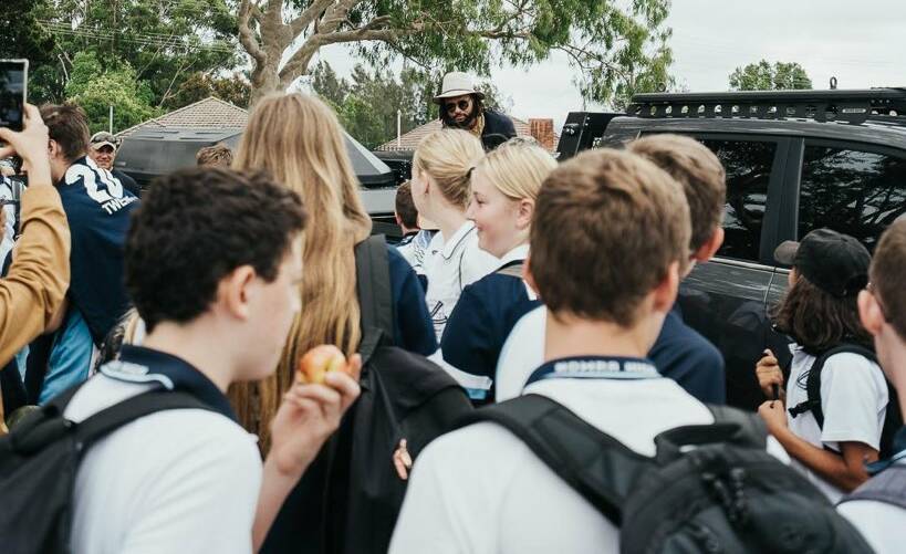 Patty Mills with students from Nowra High School on Monday. Photo: TWITTER