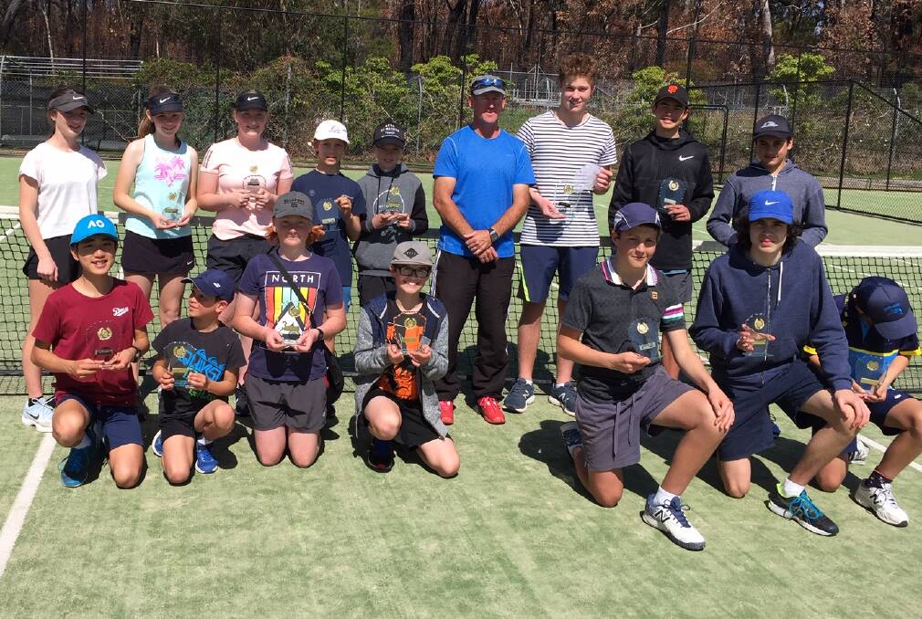 Grand finalists: At left, coach Natasha with Division 2 players, Tiahna, Anto, Harry, Jye, Adrian, Thomas, James and Lucas. At right, coach Kev with Division 1 players Gabe, Tom, Reece, Ewan, Marcus and William.