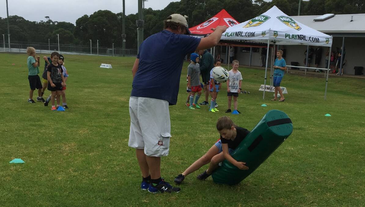 Tackling techniques: New Doggies U7 coach Jeff Howarth putting players, including Kayla Lavington, through some drills during the recent development day.