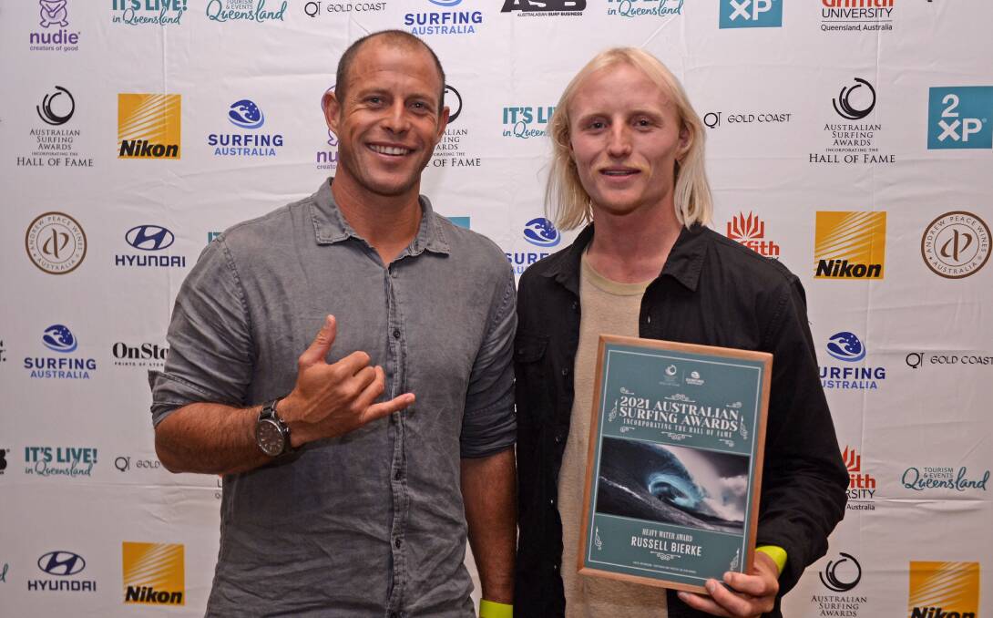 Ulladulla's Russell Bierke (right) after being presented the Heavy Water Award by Ryan Hipwood. Photo: Surfing Australia