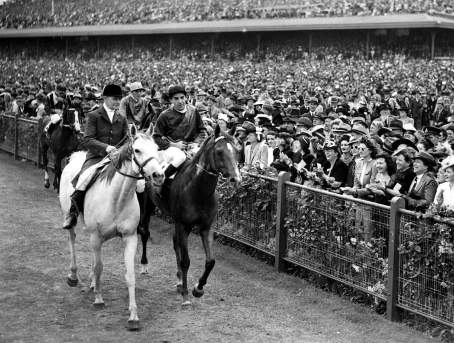 Applauding racegoers lined the lane as Russia ridden by Darby Munro accompanied by the clerk of the course trotted back to scale after his success in the Melbourne Cup.