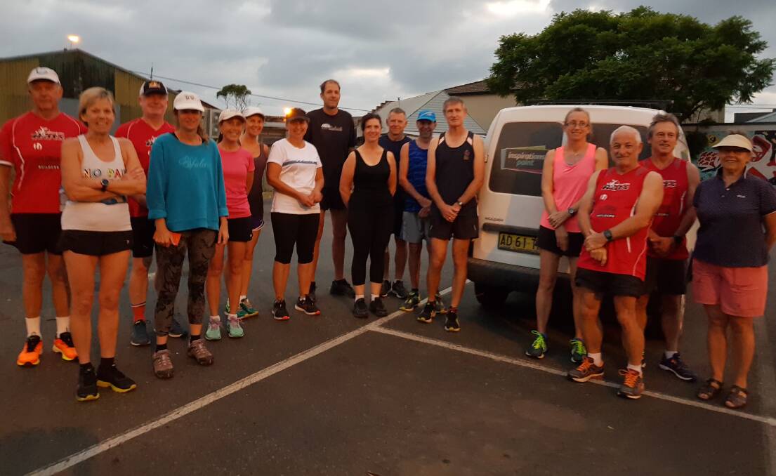 Ready to go: Ulladulla Runners and Triathletes club members gather in the early morning light before last Sunday's run.