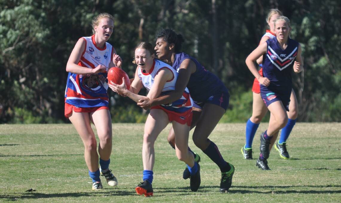 Got you: Ulladulla's Lux Selvakumaran puts a tackle on her Bulldogs opponent.