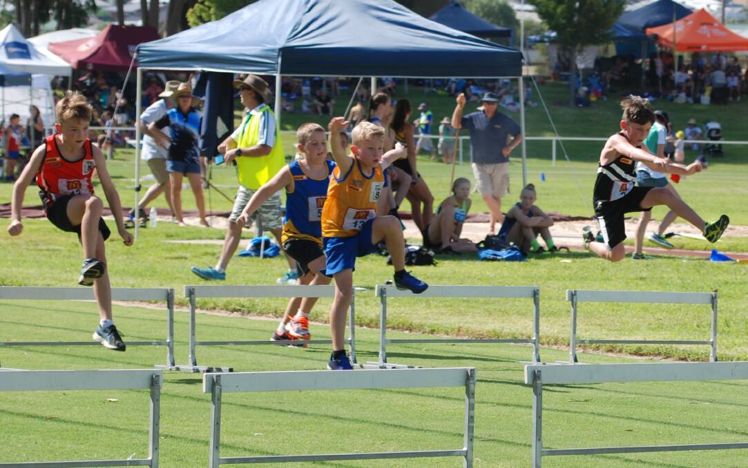 FLY WITH THE CLOUDS: Milton-Ulladulla Little Athletics' Pheonix Williams competes in the 60m hurdles at the recent regionals. Photo: MOO DATH