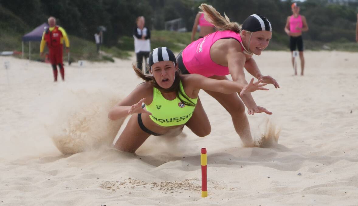 FRIENDLY RIVALRY: Mollymook's Arnae McKillop and Karla Jones go for a flag at Saturday's South Coast Branch Titles. Photo: KEN BANKS