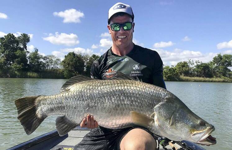 Liam Carruthers holding up the winning barramundi. Photo: Department of Defence