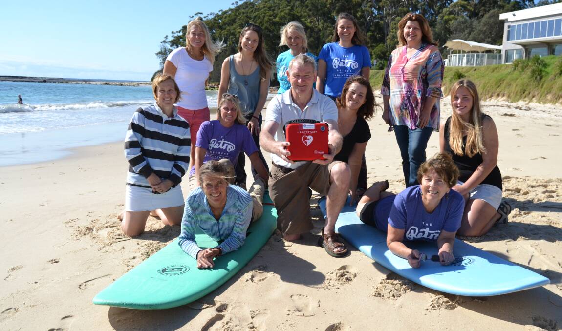 UHS Surf Princesses Denise Lofts, Kate Kinch, Karen Lissa, Lison Fabre, Trish Karaboikis, Kylie Robinson, Roz Johnston, Karyn Ingold, Louisa Dierks and Donna Miles, together with Allan McDonald from the Ulladulla Milton Lions Club fundraised to purchase a defibrillator for surfer Pam Burridge (front left). Photo: Jessica Clifford.