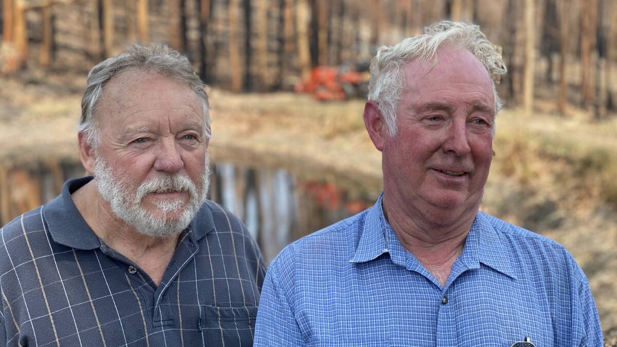 EXHAUISTED: David Freeman, right, with his old friend Les Rash, who was helping clean up the property on Wednesday. Photo: John Hanscombe